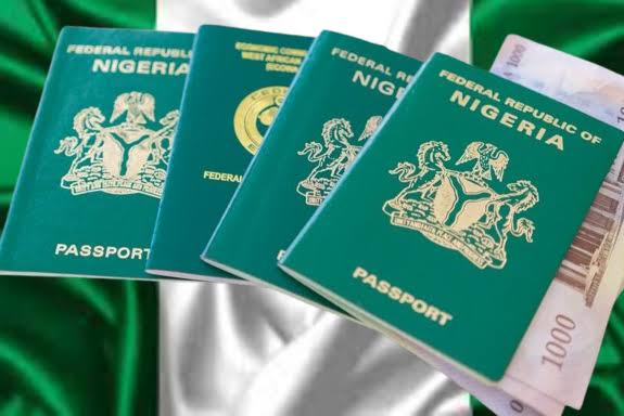 Nigerian passports with currency notes, highlighting fee review.