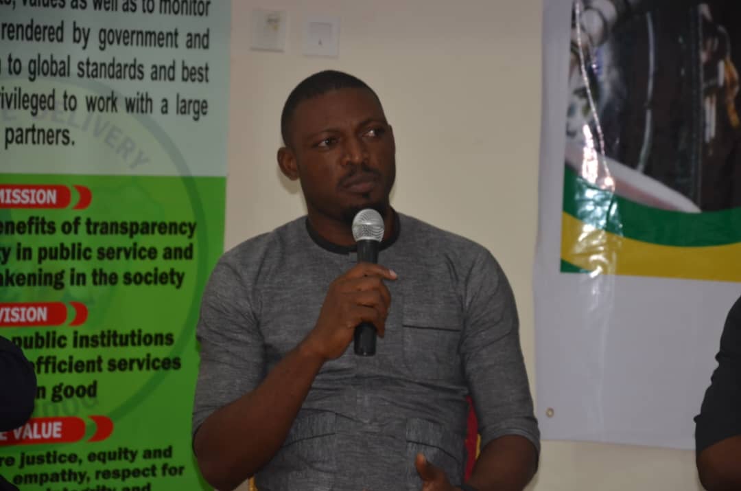 Man speaking at Belem 2025 climate change conference in Africa.