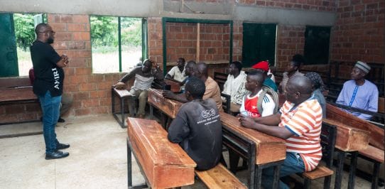 Trauma healing session with community members in Southern Kaduna classroom.