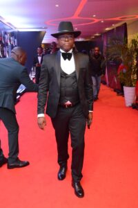 Chinedu Okeke in formal attire at Abuja digital transport event.